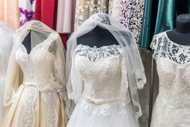 istock White dresses on mannequins in wedding salon 1034298360