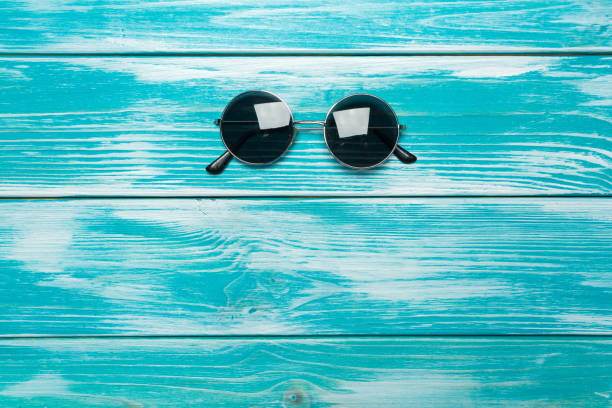 istock sun glasses on wooden table 1034298696