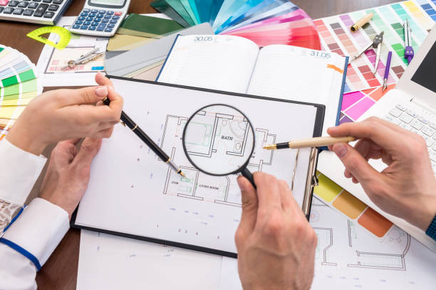 istock Team of creative designers discussing house plan in office 1034298972