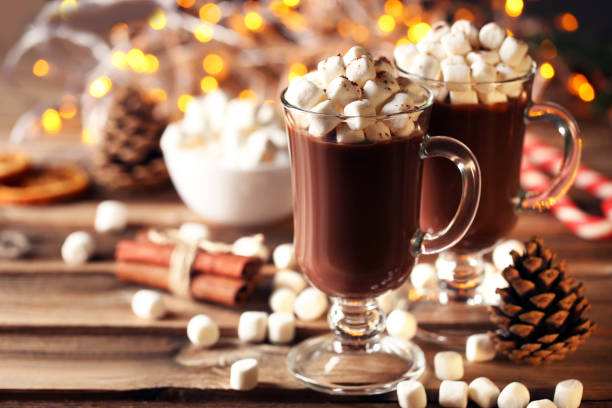 istock Cappuccino with marshmallow in glasses and cinnamon on brown wooden table 1034298980