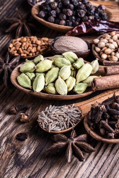 istock Different types of whole Indian spices in wooden spoons on rustic background. 1034301856