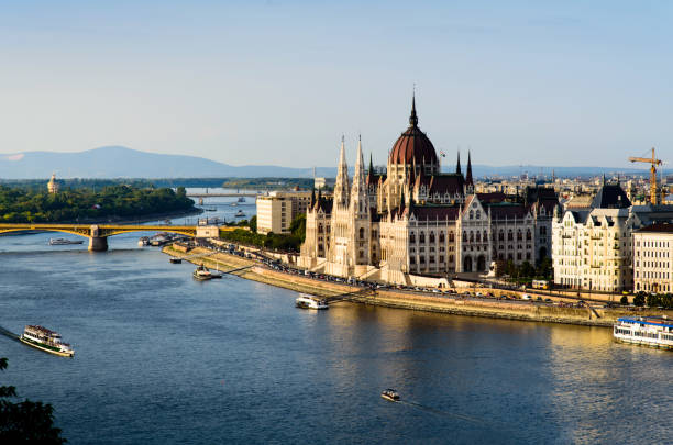 istock Hungarian Parliament in Budapest by Danube river at sunset 1034301884