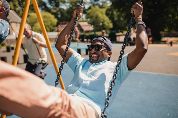 istock Senior Man Swinging High in a Public Park 1034302358