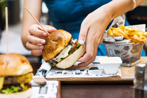 istock Girl eating burger in the restaurant 1034303176
