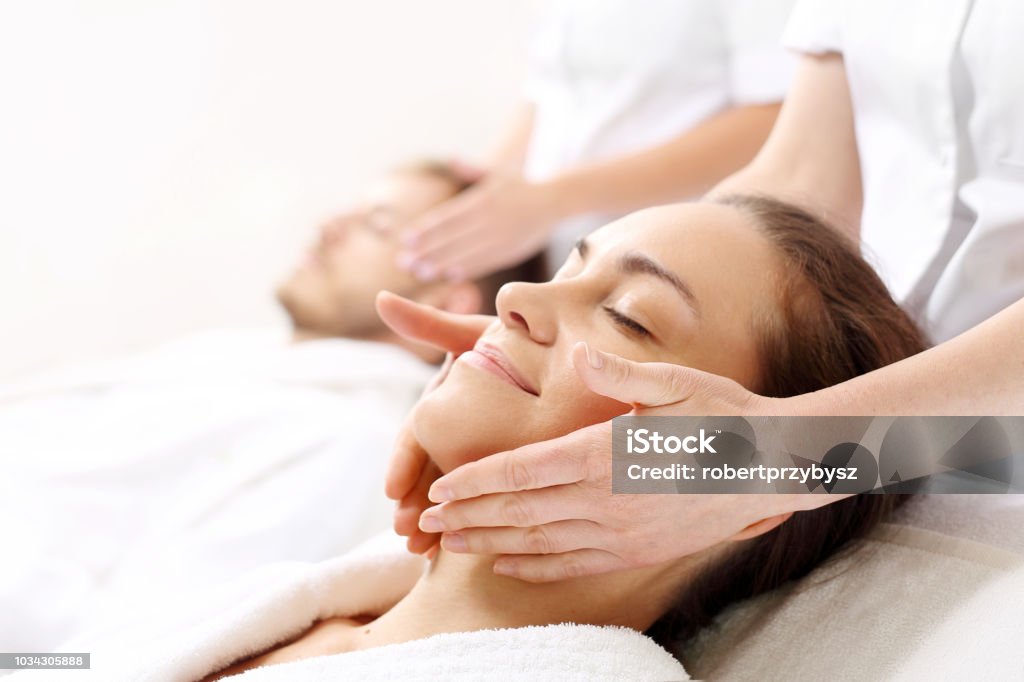 Ritual of beauty for couples A woman and a man together on a care treatment in a spa salon. Spa Stock Photo