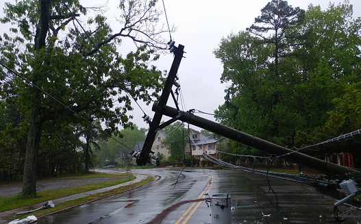 Storm damaged electric transformer on a pole and a tree damaged