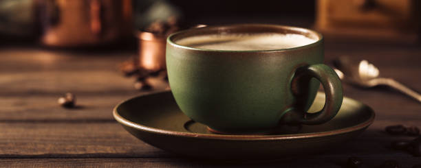 istock Green cup of coffee with coffee grinder 1034314736