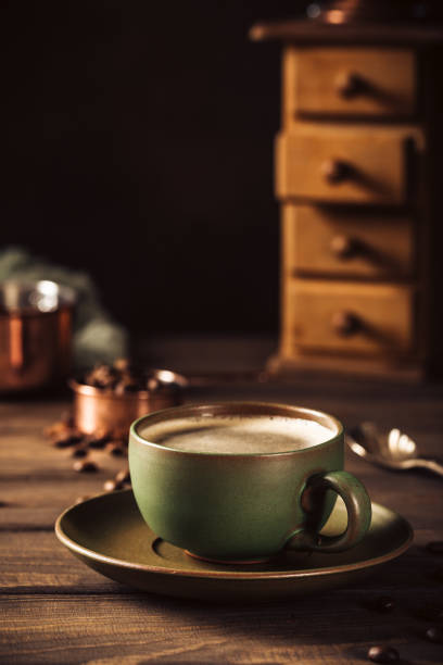 istock Green cup of coffee with coffee grinder 1034314752
