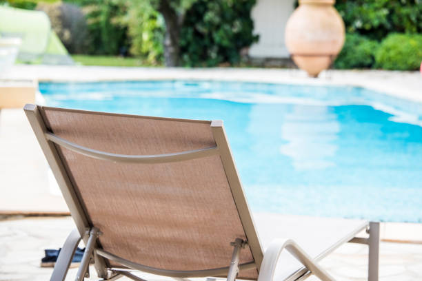 istock Pool with sun lounger 1034315108