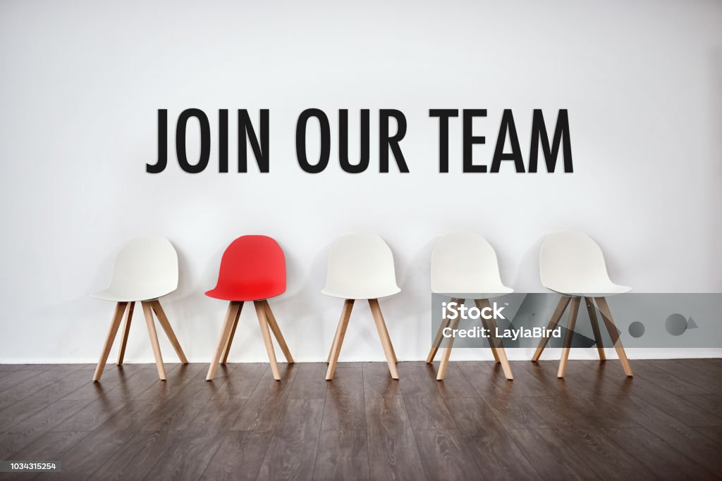 We have a spot open for a new team member Studio shot of a row of empty chairs against a gray background Recruitment Stock Photo