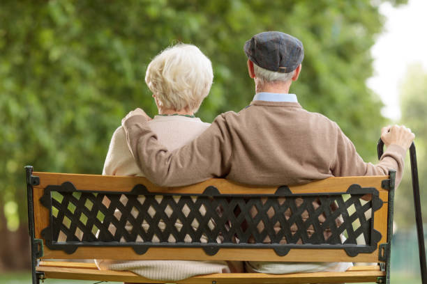 istock Senior couple sitting on a bench 1034319086