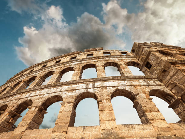 istock Pula Amphitheatre with white clouds sky, Istria, Croatia 1034319810