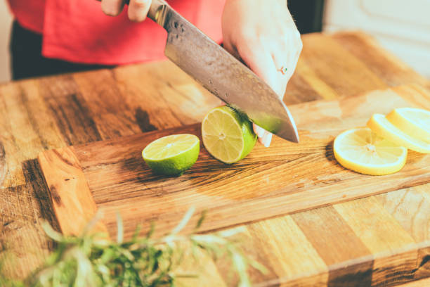 istock Close up of chef slicing lime on cutting board. 1034322664