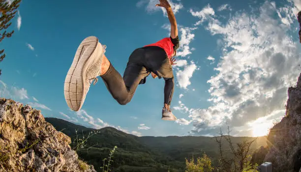 Young man cross-running on the mountain