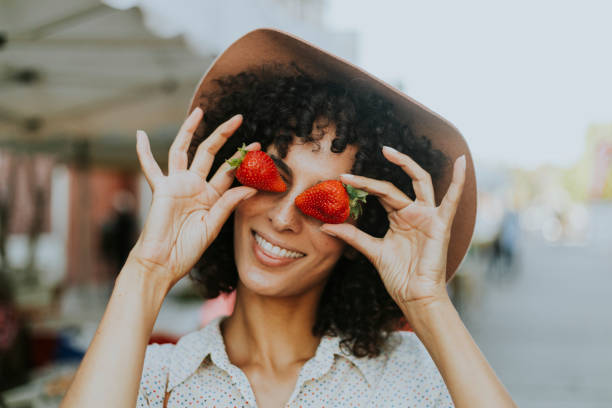 istock Woman having fun with strawberries 1034323600