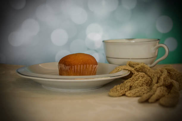 Muffins with hazelnut, cinnamon and raisins on the dark terracotta fabric napkin.