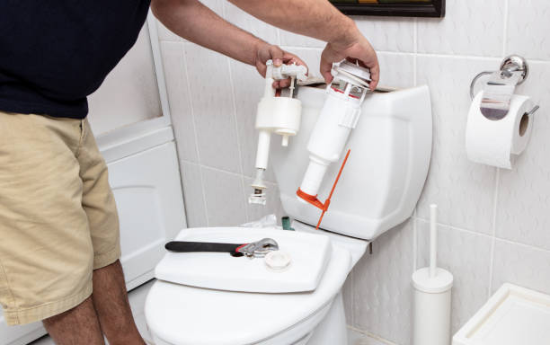 Man using tools repairing reservoir stock photo