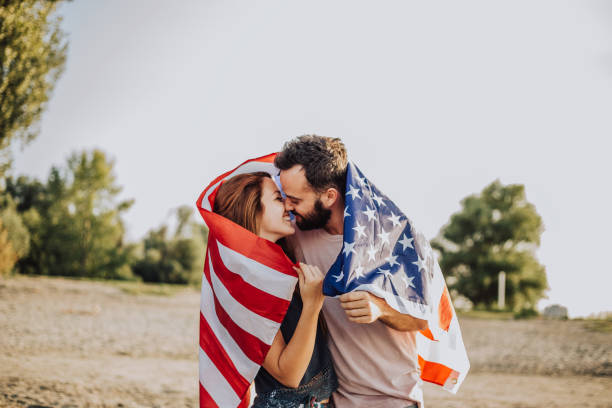 istock Happy couple under stars and stripes flag 1034330280