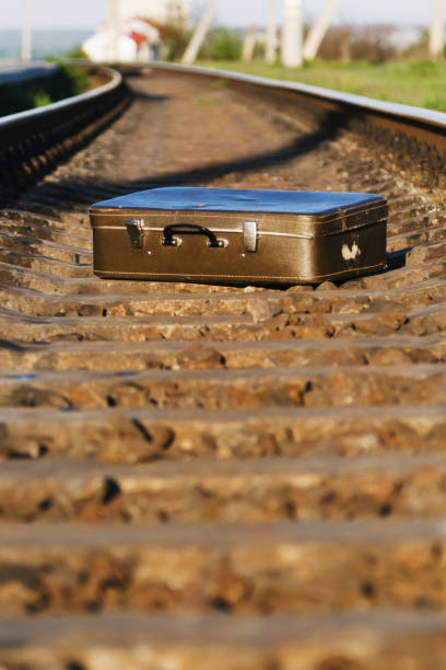 istock The old suitcase is on the railroads. 1034330566