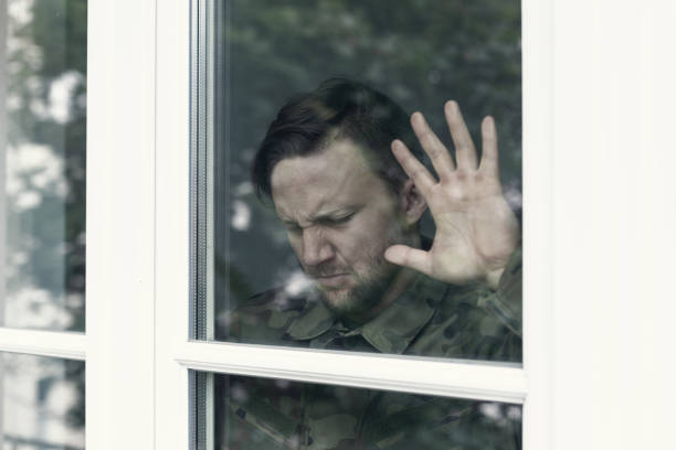 istock Depressed and tired soldier with war syndrome and violence problem 1034330886