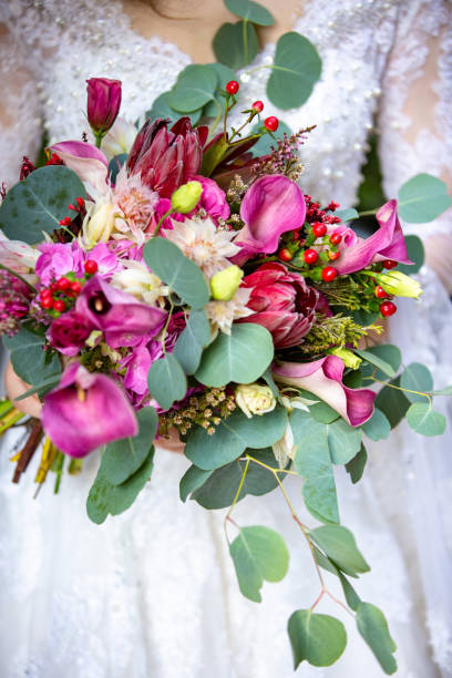 istock A bride in a wedding dress with flowers, close-up 1034334464