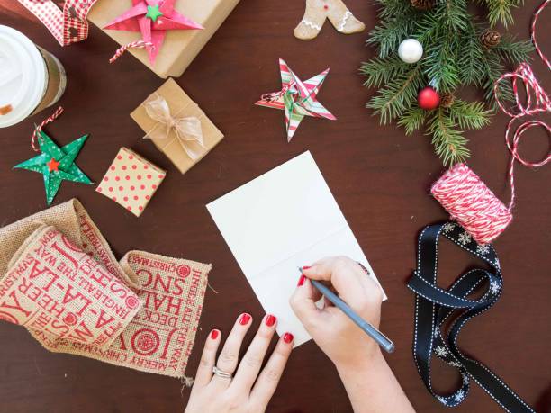 istock Hands writting Christmas card 1034334742