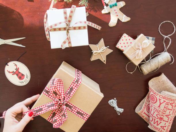 istock Hand wrapping Christmas presents and decorations 1034334844