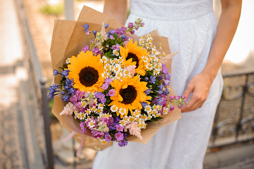 sunflower wedding bouquet in the hands of the bride. No face