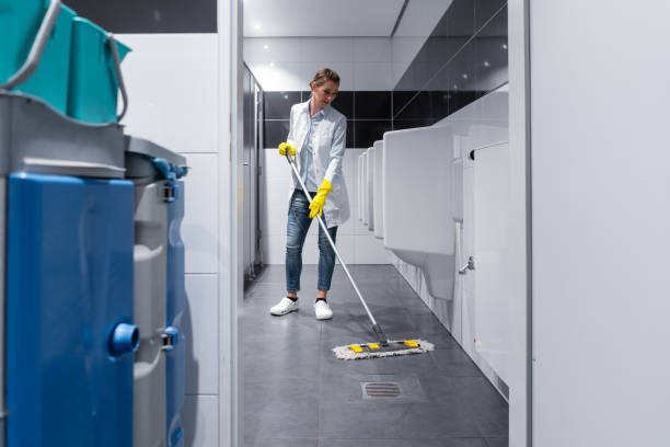 istock Cleaning lady mopping the floor in men's restroom 1034338084