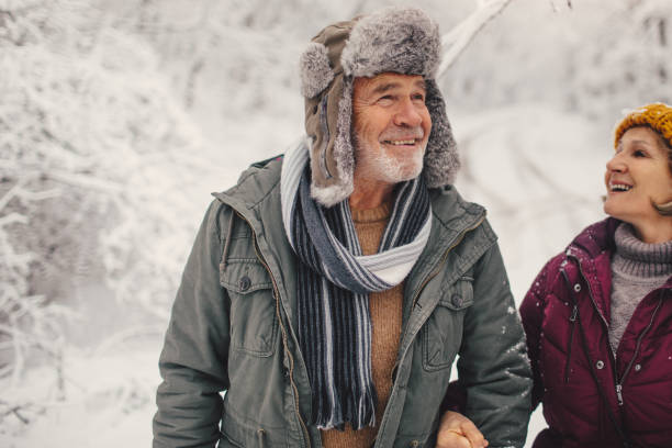 istock Senior couple enjoying a winter walk 1034341332