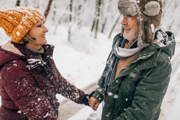 istock Senior couple enjoying a winter walk 1034341366