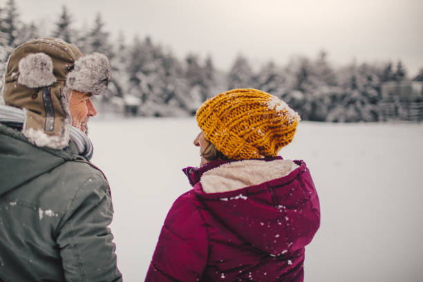 istock Senior couple enjoying a winter walk 1034341422