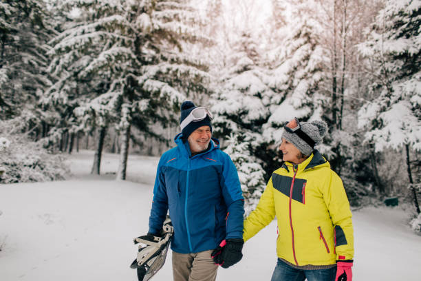 istock Senior couple walking in a ski resort 1034341428