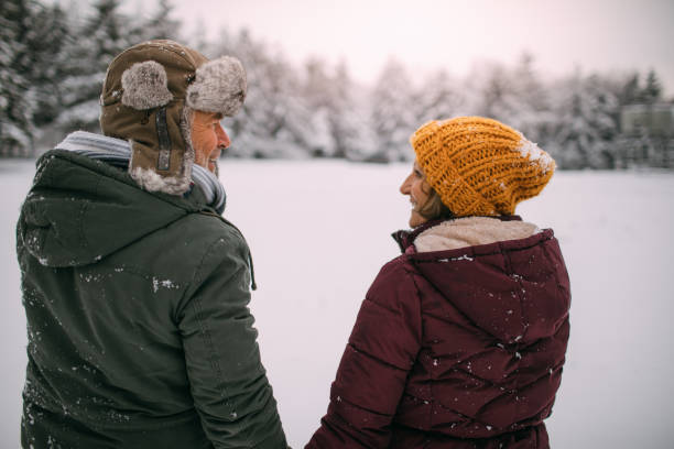 istock Senior couple enjoying a winter walk 1034341434