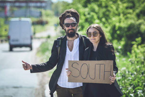 istock Attractive couple hitchhiking 1034347244