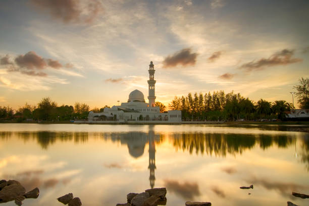 istock silhouette and reflection of mosque over magical sunset 1034348502