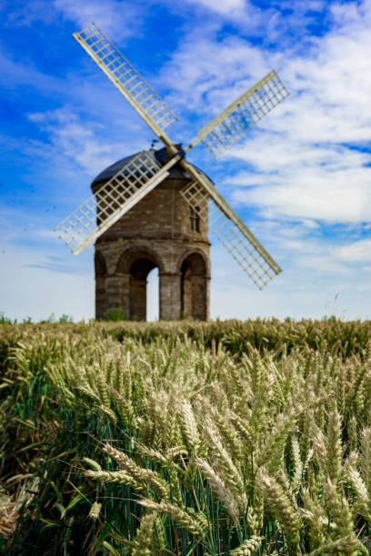 Old Windmill in Wheat Field, UK Old wood and stone windmill in Warwickshire, UK chesterton photos stock pictures, royalty-free photos & images