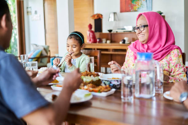 istock Multi-generation family eating food at home 1034356490