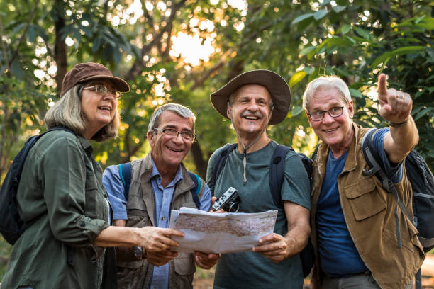 istock Group of senior trekkers checking a map for direction 1034356814