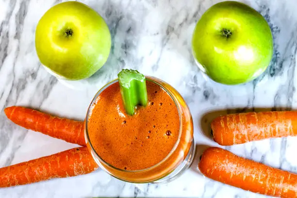 Fresh, healthy, homemade carrot juice in a glass. Top view,
