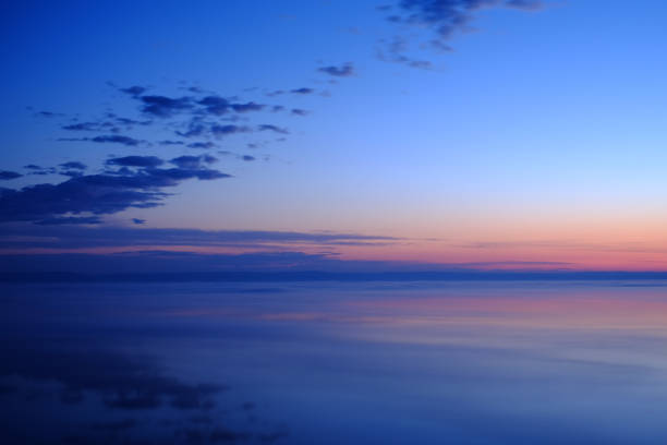 istock Beautiful sunset over sea with reflection in water. 1034362948