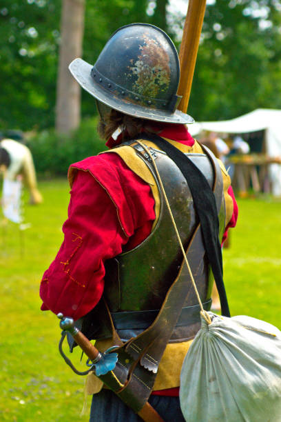 English Civil War battle re-enactment English Civil War battle re-enactment group at a Cambridgeshire Village fete. The event was part of the Kimbolton Fayre and Classic car show at Kimbolton School, Cambridgeshire. There was no fee to see the parade by the troops. civil war enactment stock pictures, royalty-free photos & images