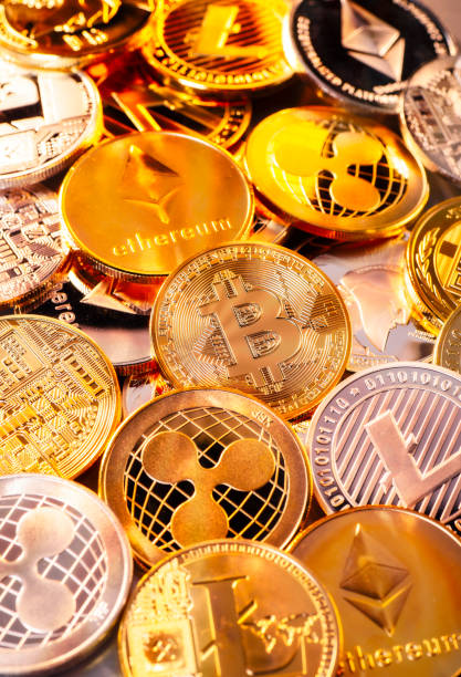 Coins of various cryptocurrencies stock photo