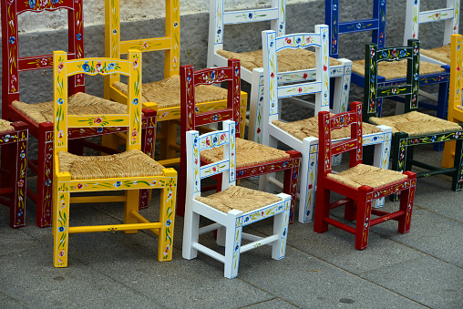 Arraiolos, Évora district, Portugal: handicrafts - colorful wooden chairs with floral motives - the seat is made with 'bunho', common club-rush (Schoenoplectus lacustris)