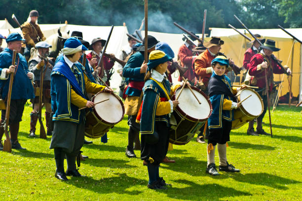 English Civil War battle re-enactment English Civil War battle re-enactment group at a Cambridgeshire Village fete. The event was part of the Kimbolton Fayre and Classic car show at Kimbolton School, Cambridgeshire. There was no fee to see the parade by the troops. civil war enactment stock pictures, royalty-free photos & images