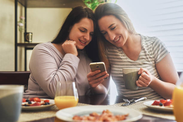 istock Helping each other update their statuses on social media 1034364002