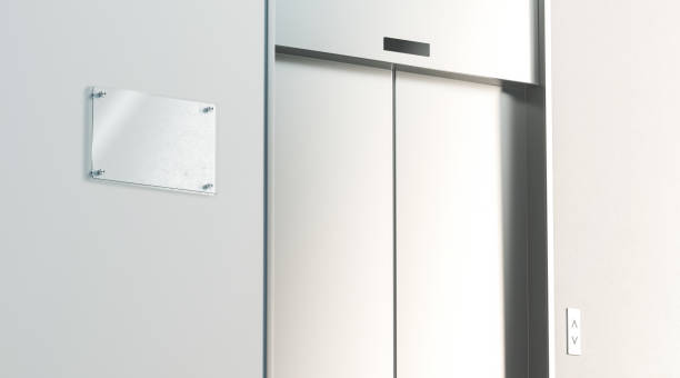 istock Blank signage near silver closed elevator in office floor interior 1034365060