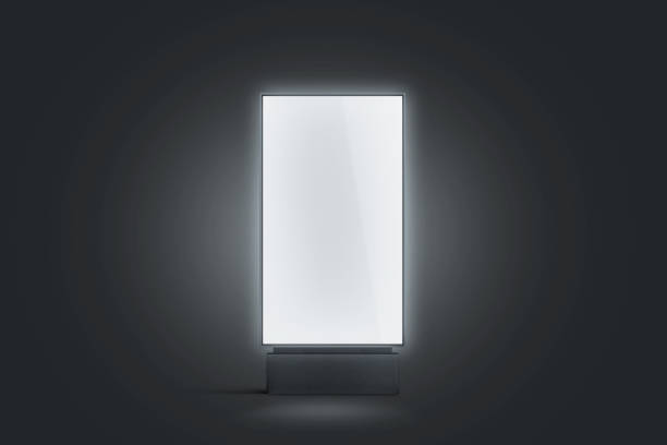 Blank white glowing pylon mockup, isolated in darkness Blank white glowing pylon mockup, isolated in darkness, 3d rendering. Empty luminous advertising panel mock up. Clear street banner front view. Outdoor sign poster tempalate. lightbox photos stock pictures, royalty-free photos & images