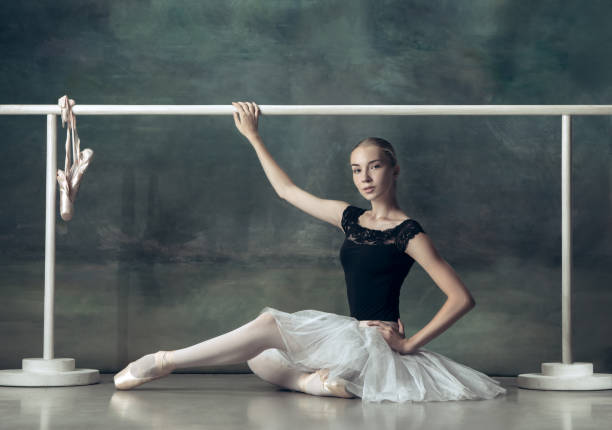 istock The classic ballerina posing at ballet barre 1034373096