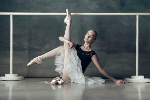 istock The classic ballerina posing at ballet barre 1034373216